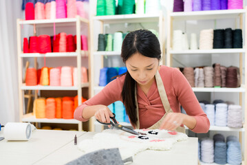 Woman make of tufting carpet at studio