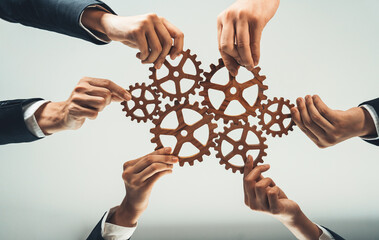 Business team joining cogwheel in circular together symbolize successful group of business...