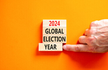 2024 global election year symbol. Concept words 2024 global election year on beautiful block. Beautiful orange table background. Voter hand. Business 2024 global election year concept. Copy space