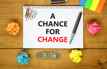 A chance for change symbol. Concept words A chance for change on beautiful white note. Beautiful wooden table background. Colored paper. Black pen. Business A chance for change concept. Copy space.