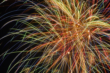 Colorful Fireworks Display at Night with Bright Streaks