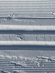 Prepared classic cross-country ski track on snow. Winter sports background - 741746382