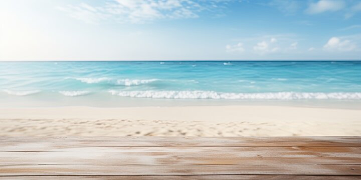 Blurred blue sea and white sand beach backdrop with a wooden tabletop.