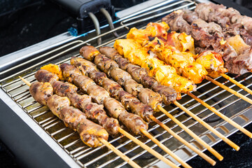Meat skewer, or brazilian traditional 'espetinho de carne' on a eletric grill