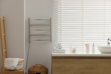 Stylish bathroom interior with heated towel rail and vanity