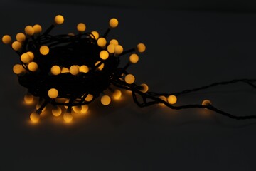 Beautiful glowing Christmas lights on dark background