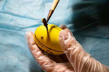 Painting Easter eggs with wax and creating patterns. Ukrainian traditions for Easter