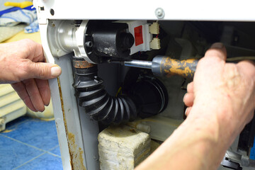 Replacing the pump in a washing machine.