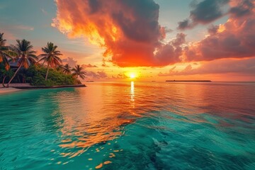 Fototapeta na wymiar Beach sunset over water with palm trees on tropical island