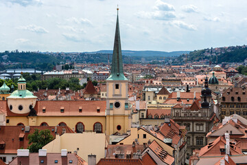 View of the city roofs of red tiles in old Prague from the wall of Prague Castle.