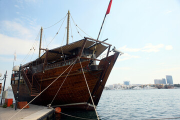 Wooden boat docked at the pier in the port of Dubai United Arab Emirates.
