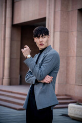 Oriental, asian man model stands outdoor. Fashion, city portrait.