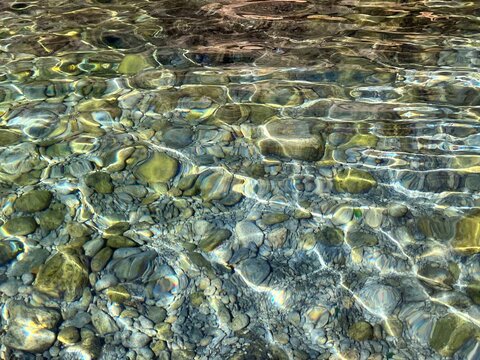 Sea water pebbles gravel stones underwater. 