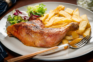 Appetizing baked chicken leg quarter.