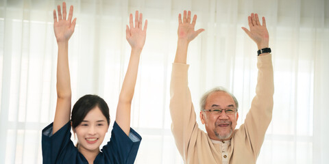 Young asian female nurse care giver helping asian senior old man in living area of nursing home...