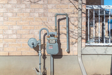 Gas meter on a brick wall of a house