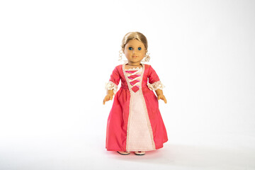 Красивая кукла в красном платье . На белом фоне