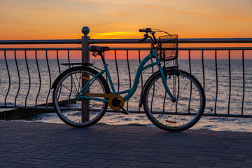 Scenic sunset sea landscape. dramatic sky and horizon at sunset time, bike at the embankment