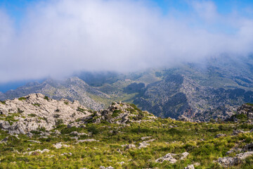 Amazing landscapes of Mallorca. Majestic mountains covered with clouds, Sunny day. Mallorca, Spain, Balearic Islands