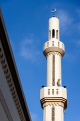 Minaret of the mosque against blue sky in Abu Dhabi, UAE