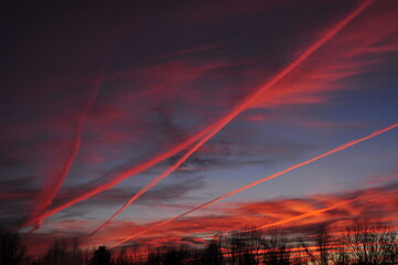 Winer sunset with condensation trails