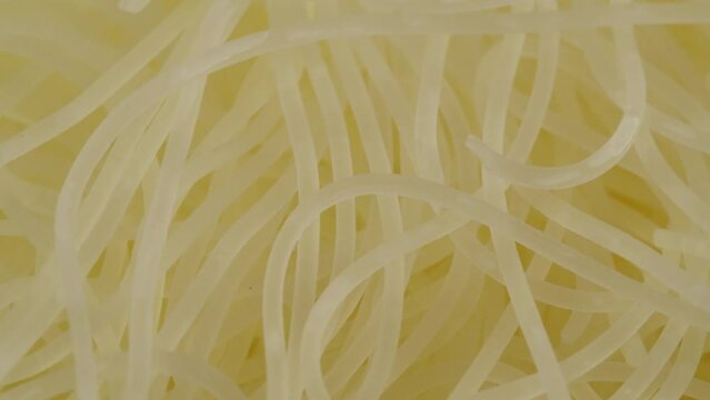 Close-up of instant noodles texture. Asian fast food with meat and spices. Instant noodles, or instant ramen, is a type of food consisting of noodles sold in a precooked and dried block with