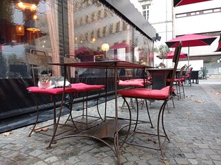 cat, parasol and red chair cushions on the outdoor  terrace of a  restaurant in Draguignan,  southern France