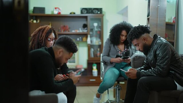 Group of 4 people hypnotized by their phones inside technological bubbles ignoring each other depicting isolation due to to smartphone use. bubble tech - social disconnection