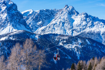 Cable car gondola against snow covered Dolomites in Kronplatz, Italy