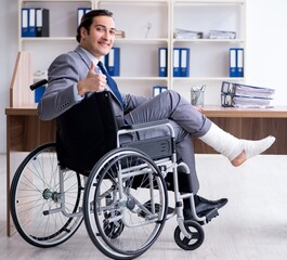 Male employee in wheel-chair in the office