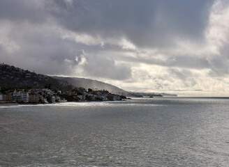 sunlight breaks through the storm clouds over the coast