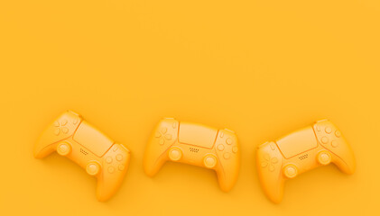 Video game joysticks or gamepads in plain monochrome yellow color background © Vasyl Onyskiv