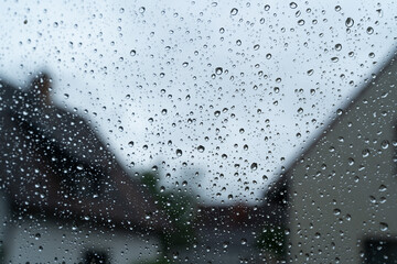 Wet window with rain drops on a rainy day 