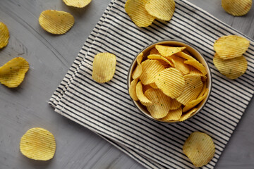 Organic Crinkle Sour Cream and Onion Potato Chips in a Bowl, top view. Flat lay, overhead, from above.