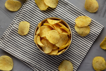 Organic Crinkle Sour Cream and Onion Potato Chips in a Bowl, top view. Flat lay, overhead, from above.