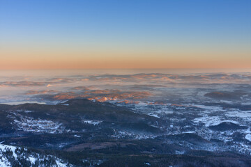 Winter, sunrise time, Karpacz view from Snezka , krkonose mountains. Snezka is mountain on the border between Czech Republic and Poland.