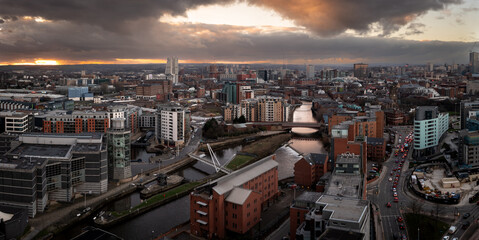 Aerial panorama of Leeds Dock and River Aire in a cityscape skyline at sunrise