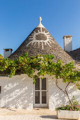 Alberobello Italy - traditional trulli houses with conical stone roofs. Famous landmark, travel destination and tourist attraction near Bari in Puglia, Europe. Old Mediterranean architecture.