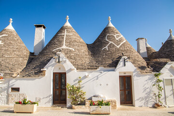 Alberobello Italy - traditional trulli houses with conical stone roofs. Famous landmark, travel destination and tourist attraction near Bari in Puglia, Europe. Old Mediterranean architecture.