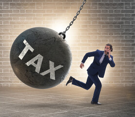 Businessman running away from high taxes