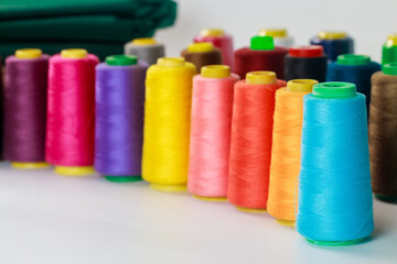 For sewing, a set of colored thread spools.