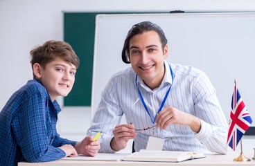 Male english teacher and boy in the classroom