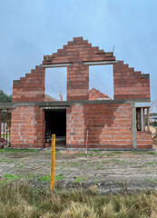 Fototapeta premium Construction of a house using slotted brick technology in autumn and winter conditions