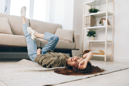 Cozy Woman Relaxing on Modern Sofa in Peaceful Apartment