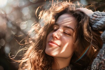 A serene woman with closed eyes exudes beauty and inner peace, her long brown hair cascading over her layered clothing as she radiates a genuine smile in the natural outdoor portrait