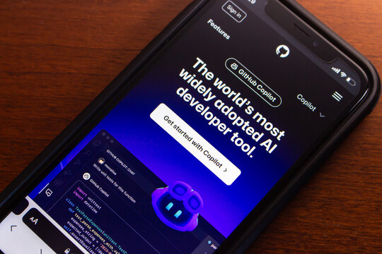 Vancouver, CANADA - Feb 14 2024 : Github Copilot website seen in iPhone. GitHub Copilot is an AI-driven code completion tool that suggests code lines or entire functions to programmers as they type.