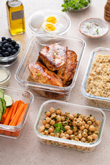 Meal prep containers with healthy food prepped, cooked chicken, quinoa, chickpeas and eggs