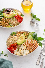 Healthy lunch bowl with high protein food, sliced grilled chicken, chickpeas and quinoa