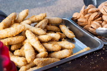 Indonesian street food, fried otak otak. Served with sauce or various flavors of powdered spices.