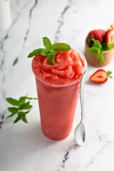 Strawberry watermelon smoothie or slushie in a tall cup